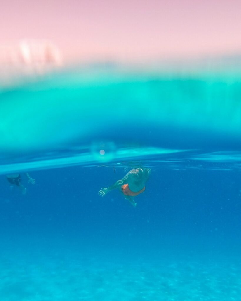 2 people surfing on water during daytime